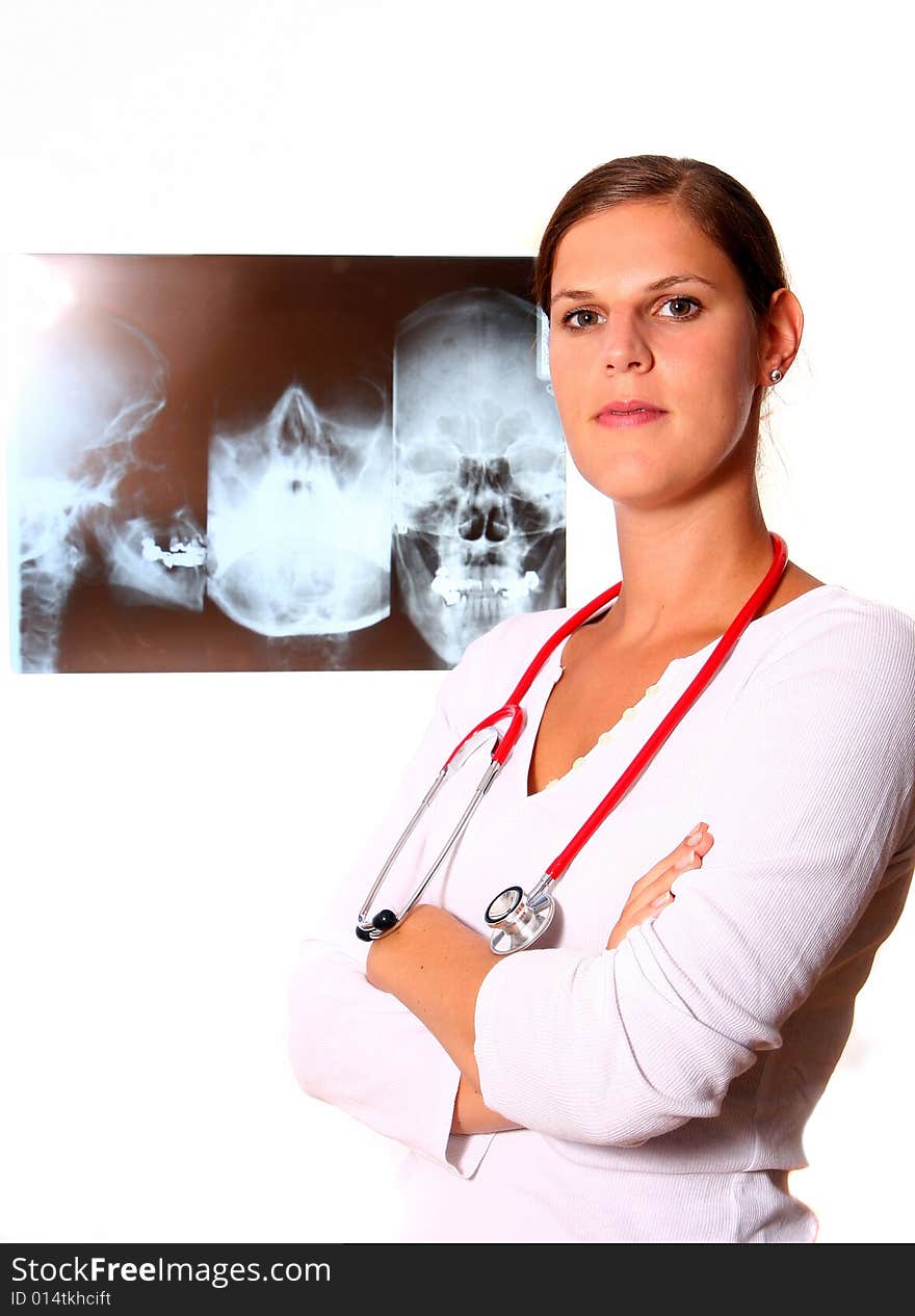 A beautiful young doctor with a red stethoscope and a xray image in the back. Isolated over white. A beautiful young doctor with a red stethoscope and a xray image in the back. Isolated over white.