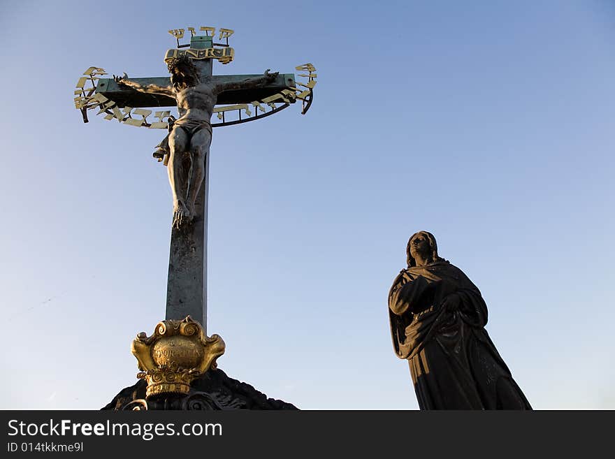 Sunset view on statuary of the Calvary Cross (Crucifix from 1629, statues by Emanuel Max 1861) standing on Charles Bridge.