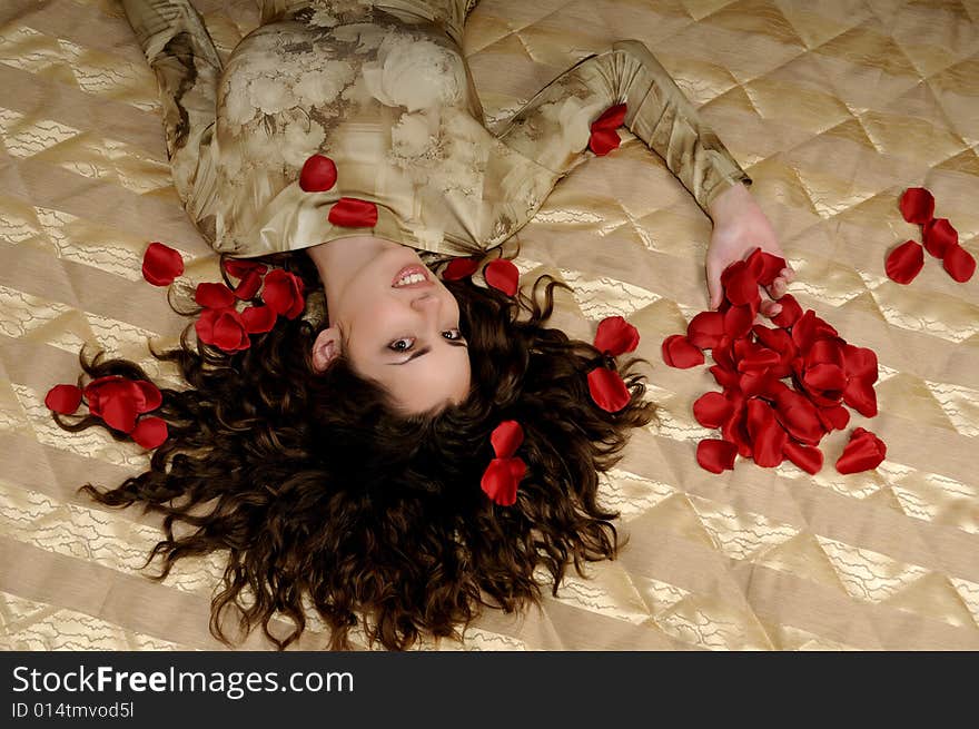 Beautiful smiling woman with red rose petals. Beautiful smiling woman with red rose petals