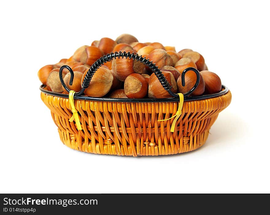 Wood nuts in a basket on white background