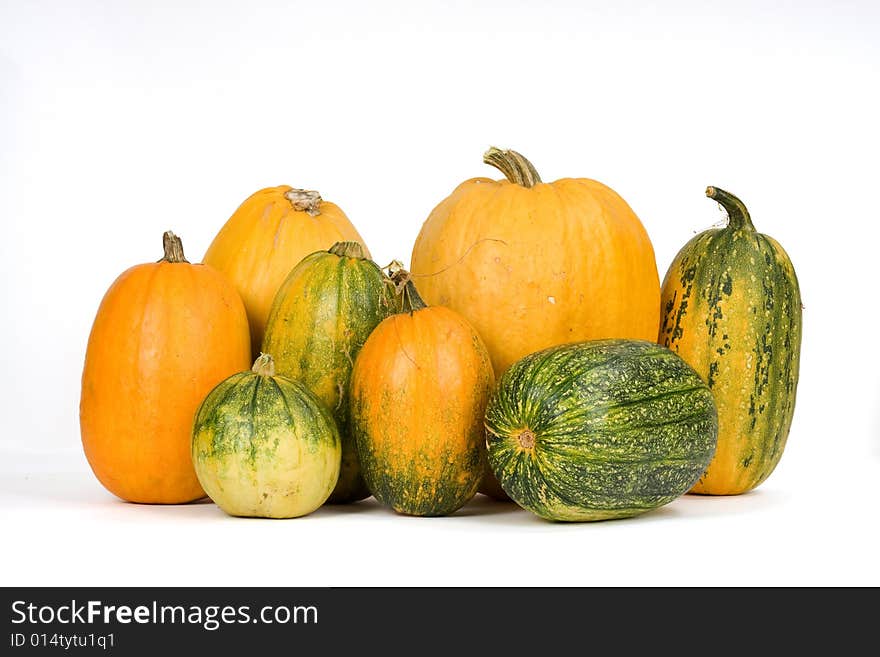 Orange and green pumpkins against white background