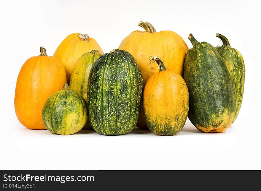 Orange and green pumpkins against white background