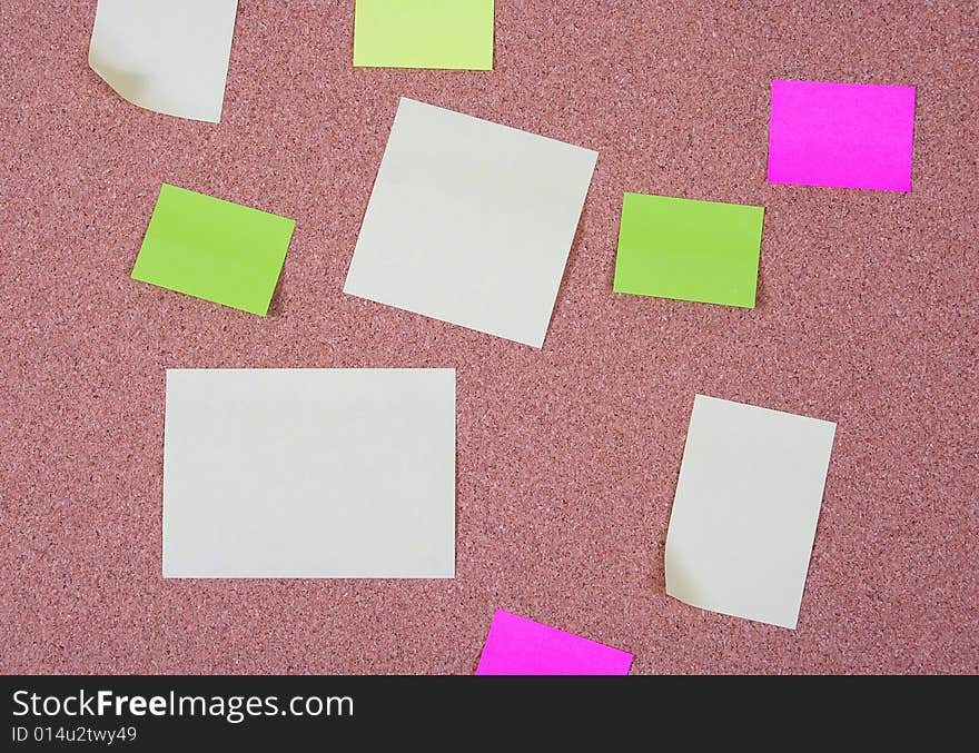 Pieces of note paper on a cork bulletin board