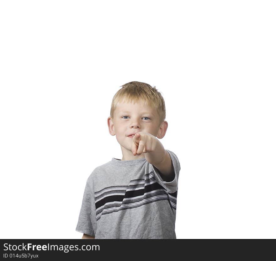 A happy boy points towards the camera. A happy boy points towards the camera