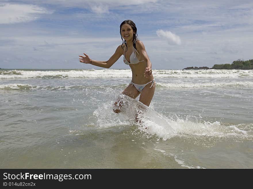 Female Teenager Jumps On The Beach