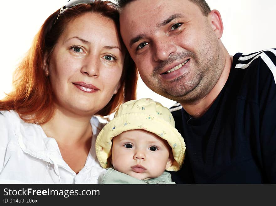 Family portrait in studio. Parents with a baby.