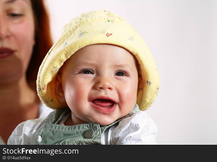 A woman with happy baby in her hands. A woman with happy baby in her hands