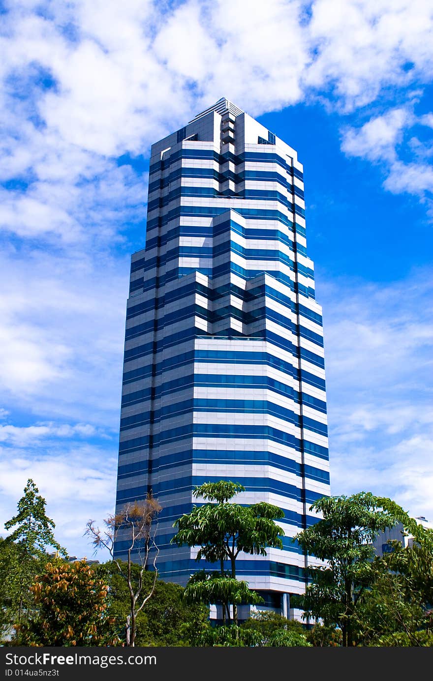 Modern single commercial building against blue sky. Modern single commercial building against blue sky