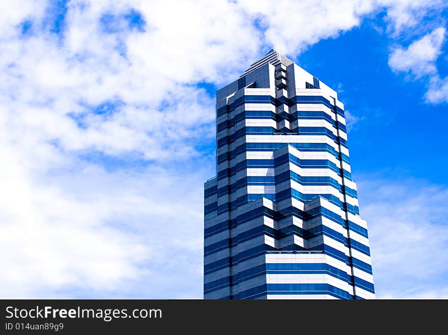 Modern single commercial building against blue sky. Modern single commercial building against blue sky