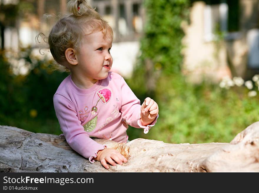 An image of little baby-girl playing outdoor. An image of little baby-girl playing outdoor