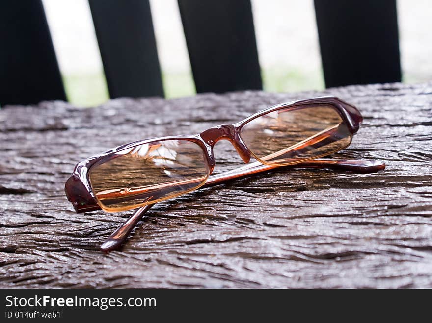 Brown classical sun glass on wooden chair