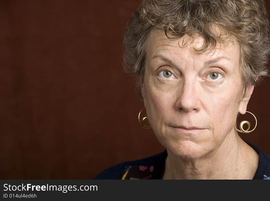 Portrait of a smiling senior woman in an embroidered shirt. Portrait of a smiling senior woman in an embroidered shirt