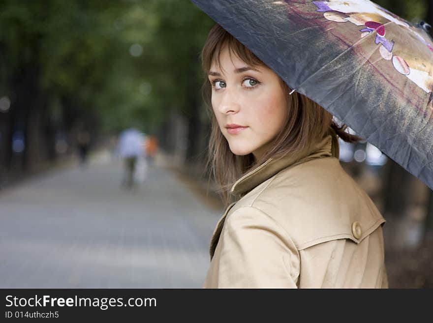 Portrait of a young beautiful woman with umbrella