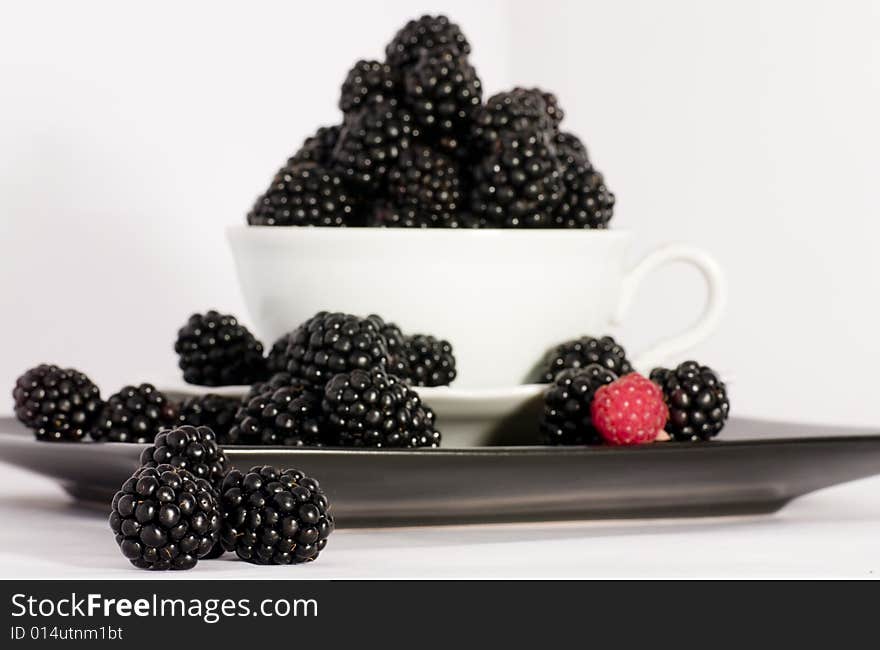 Macro view of fresh ripe blackberries in the bowl. Macro view of fresh ripe blackberries in the bowl