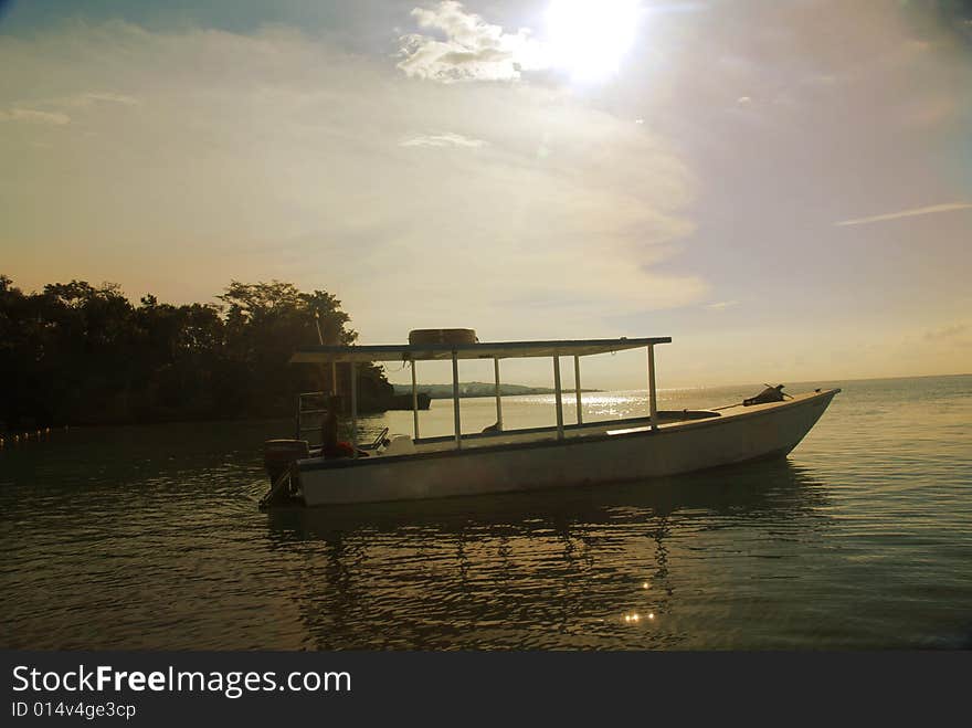 A boat on the water in sunset. A boat on the water in sunset