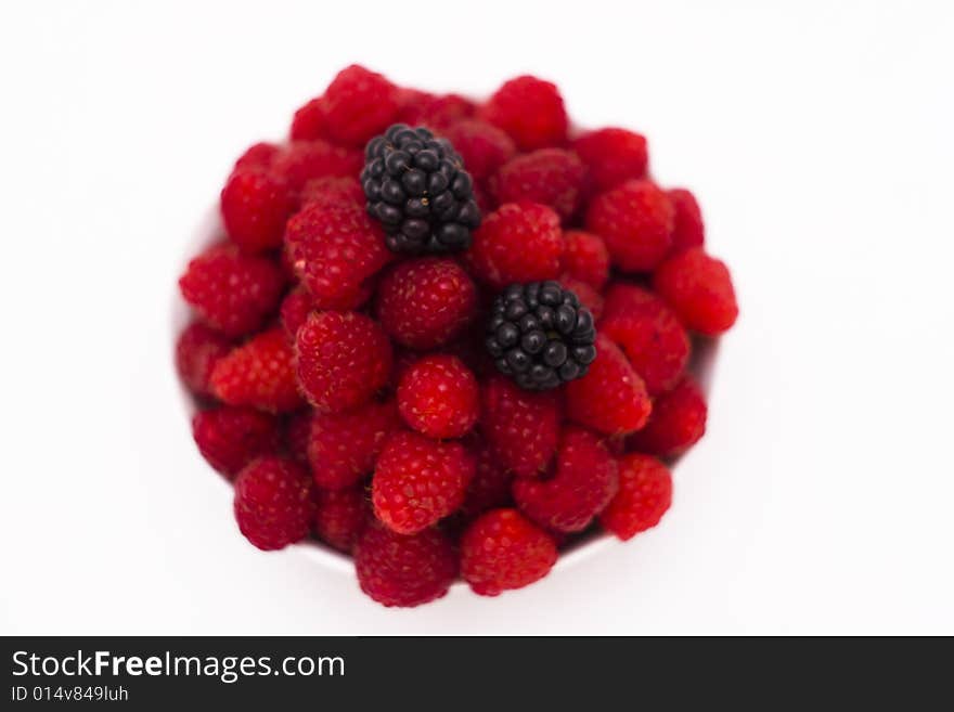 Bowl full of raspberries and wild raspberries