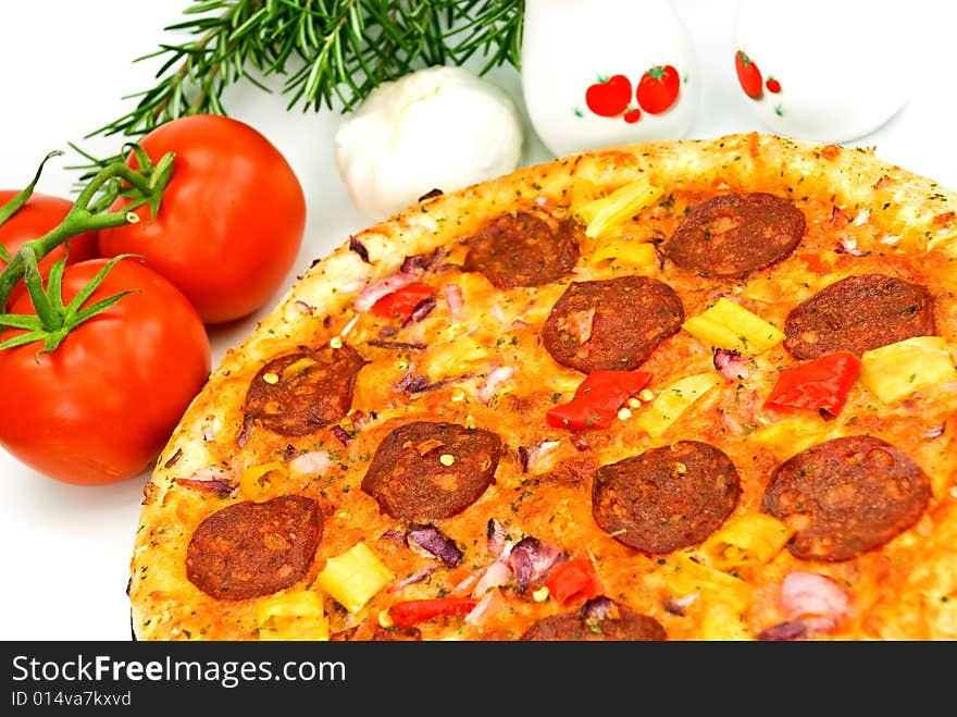 A big pizza with cheese,salami,tomatoes