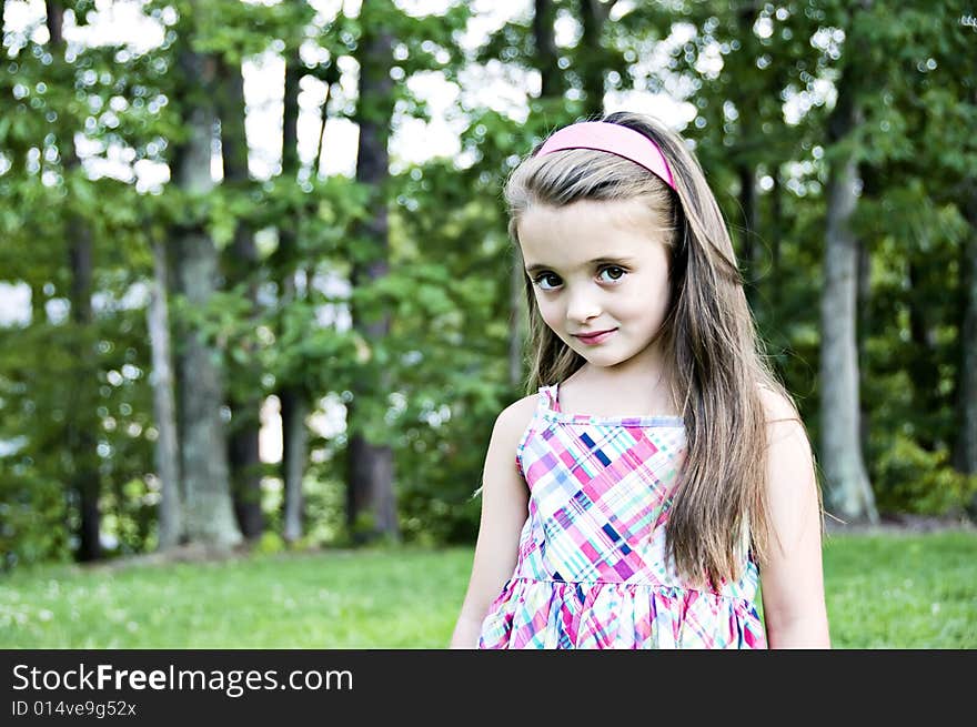 Closeup of a brunette, brown eyed girl with long hair and a pink headband. Closeup of a brunette, brown eyed girl with long hair and a pink headband.