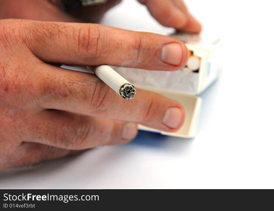 Shot of a hand holding a cigarette. Shot of a hand holding a cigarette