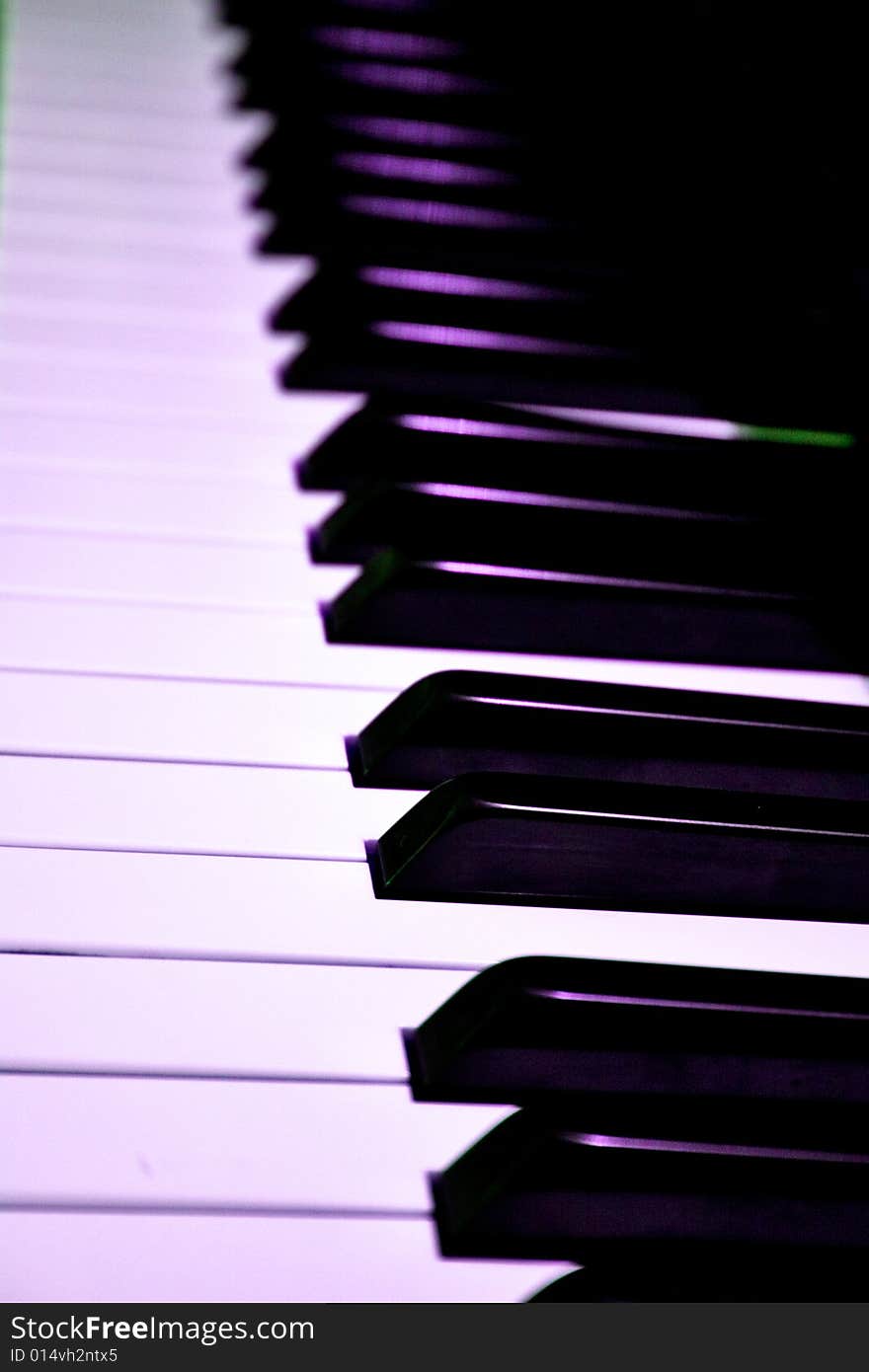 Closeup of piano keys with stage lighting reflecting. Closeup of piano keys with stage lighting reflecting.