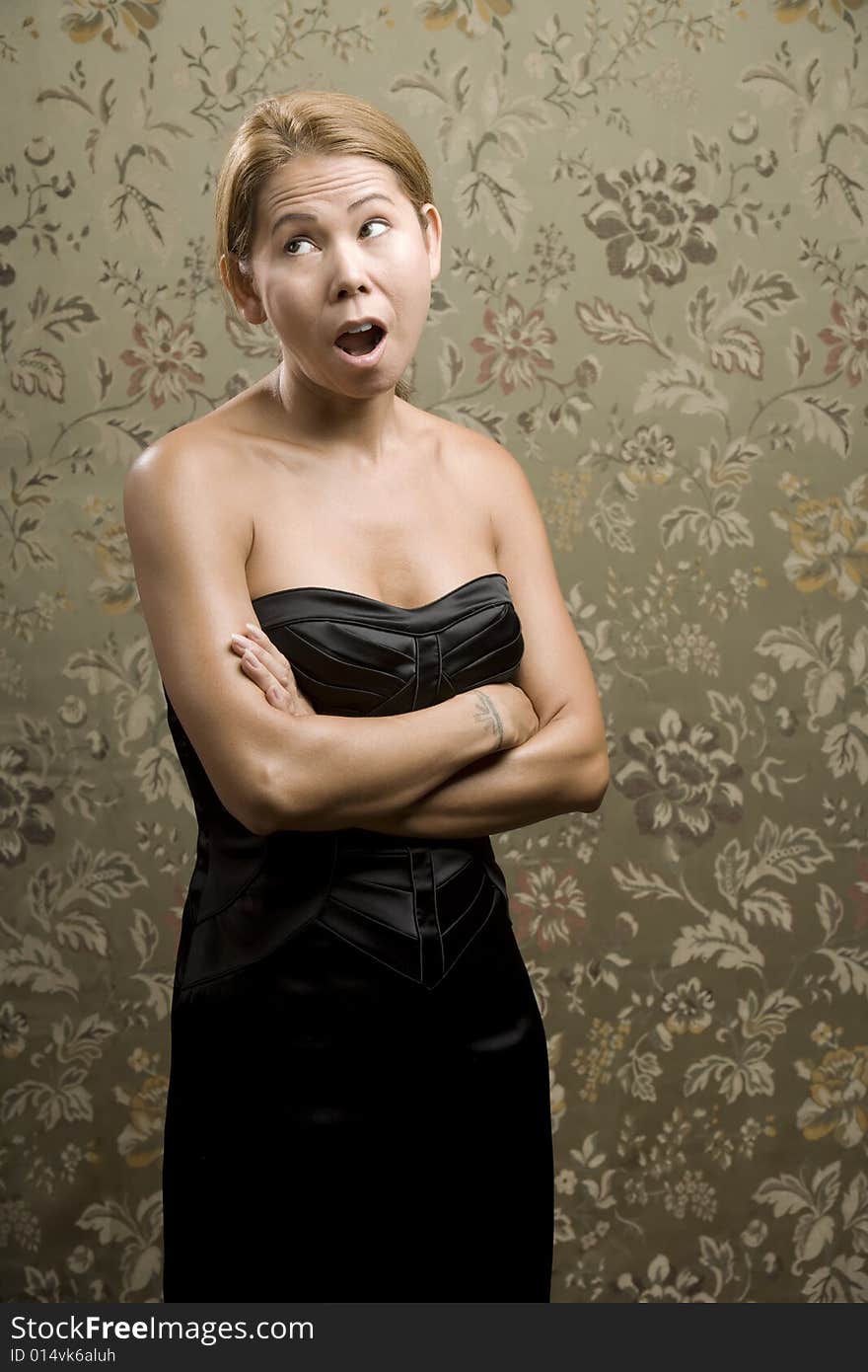 Pretty Ethnic Woman Making Funny Face in Front of Flowered background. Pretty Ethnic Woman Making Funny Face in Front of Flowered background