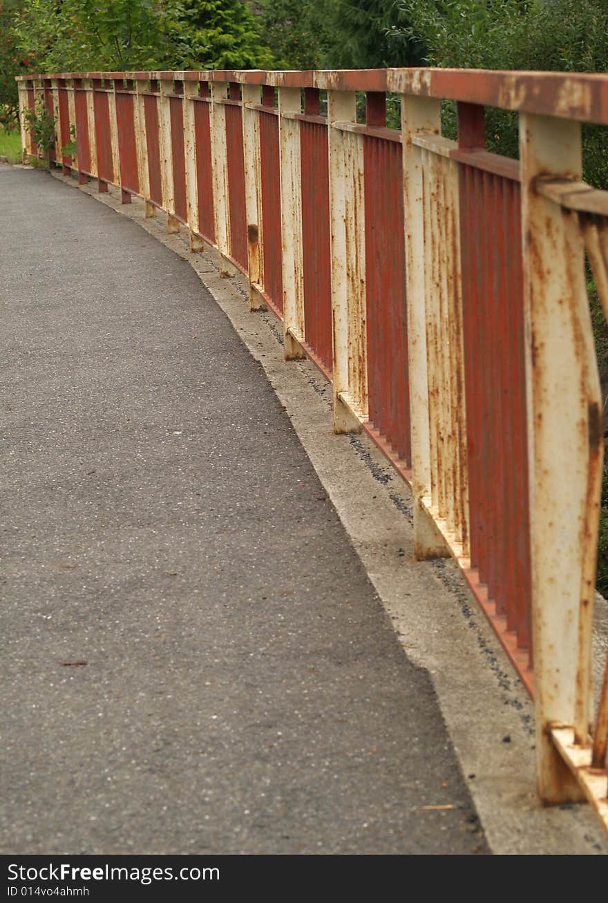 Railing on bridge with pavement