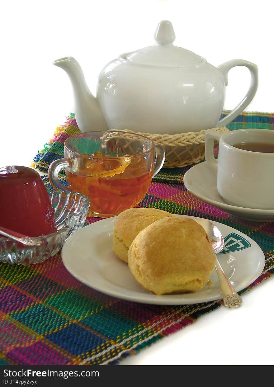 English breakfast with tea, scones, jelly and marmalade on a white background