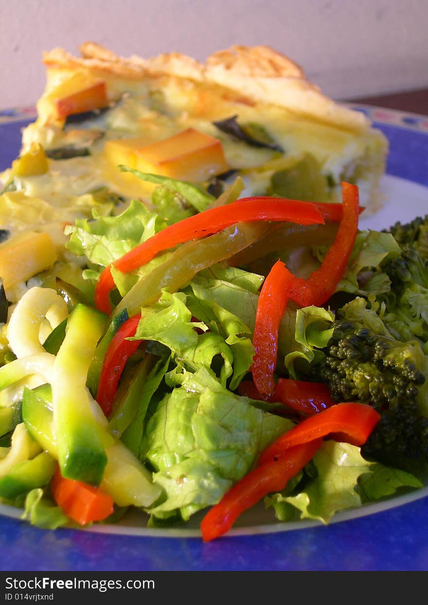 Green pumpkin pie with vegetarian salad in a restaurant table