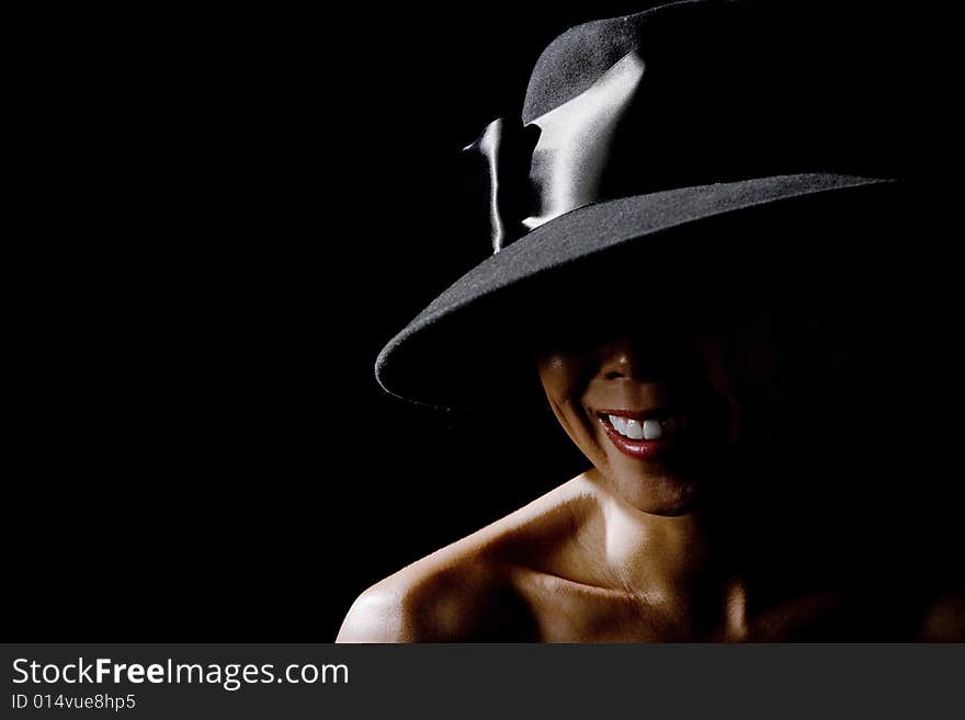 Mysterious shadowy woman in a big black hat. Mysterious shadowy woman in a big black hat