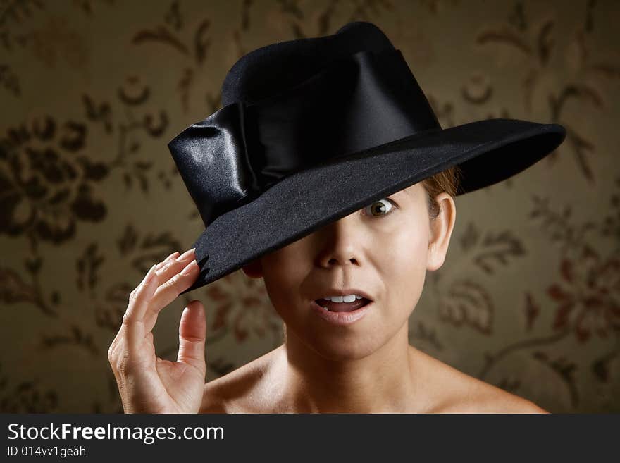 Surprised ethnic woman in a big black hat. Surprised ethnic woman in a big black hat