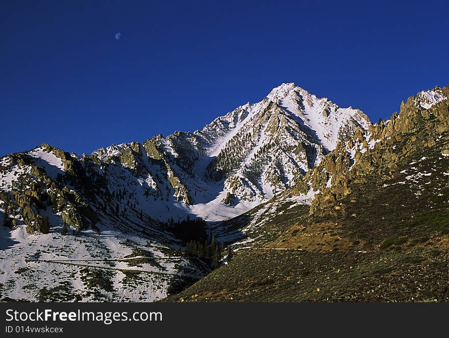 Snowy mountain peak with moon. Snowy mountain peak with moon