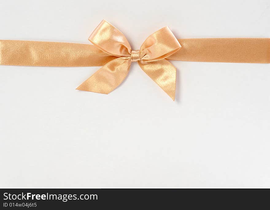 Gift box with light golden ribbon isolated on white