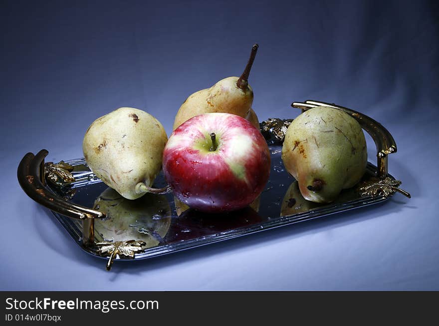 Apple and pears on tray with light brush