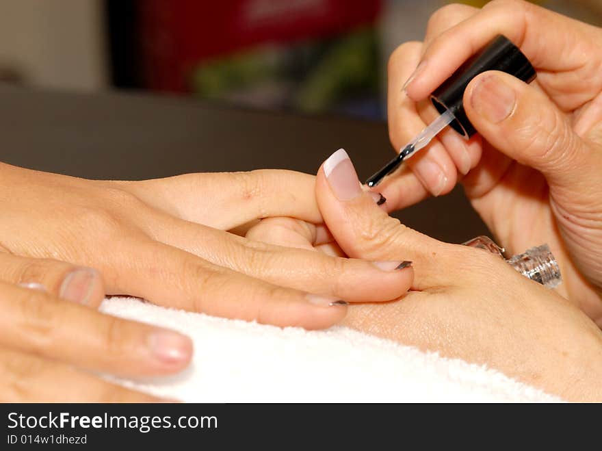 Manicurist works on customer nails. Manicurist works on customer nails