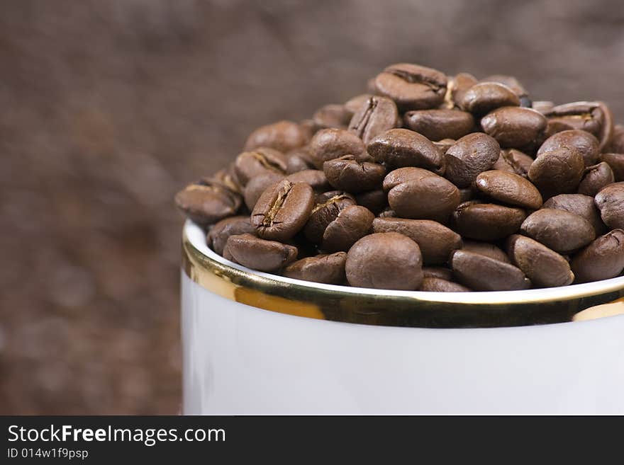 Coffee beans in a white cup. Coffee beans in a white cup