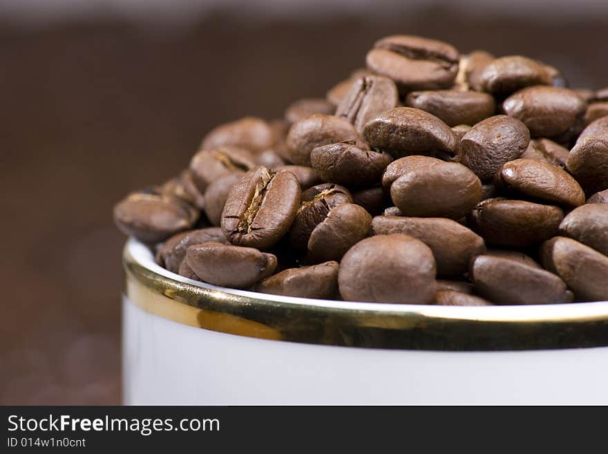 Coffee beans in a white cup. Coffee beans in a white cup