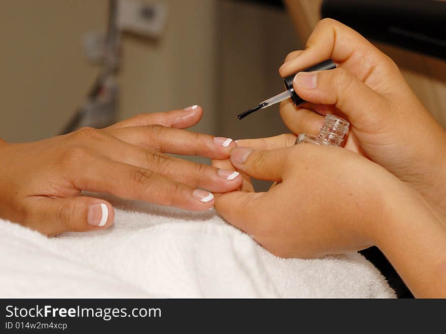 Manicurist works on customer nails. Manicurist works on customer nails