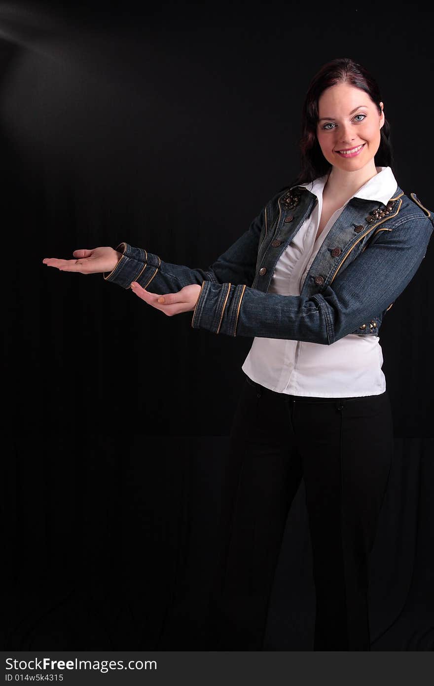 Young woman showing something on black