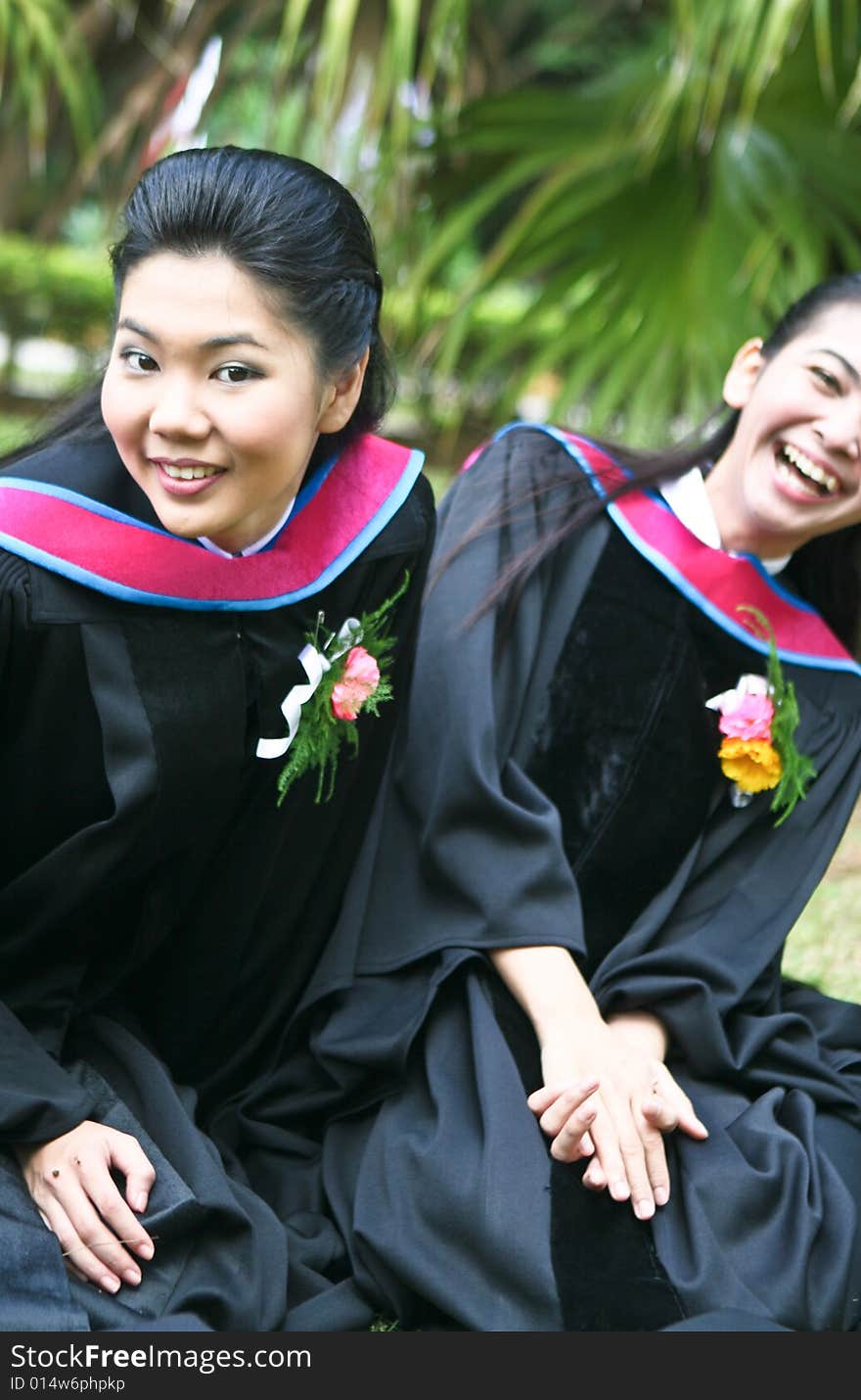 Gorgeous Asian university graduates celebrating their success.