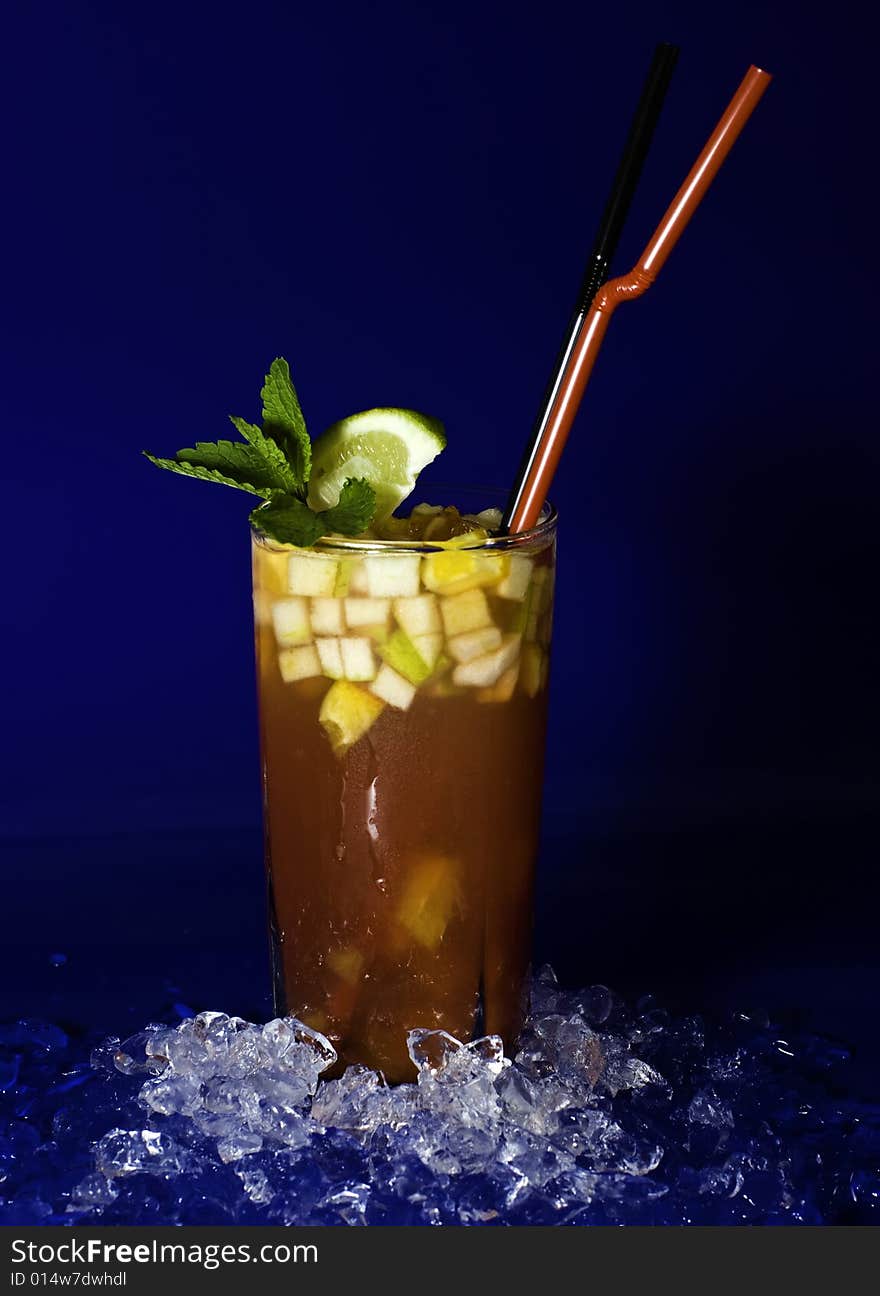 Coctail with fruit cubes, mint and lime in the weeping glass