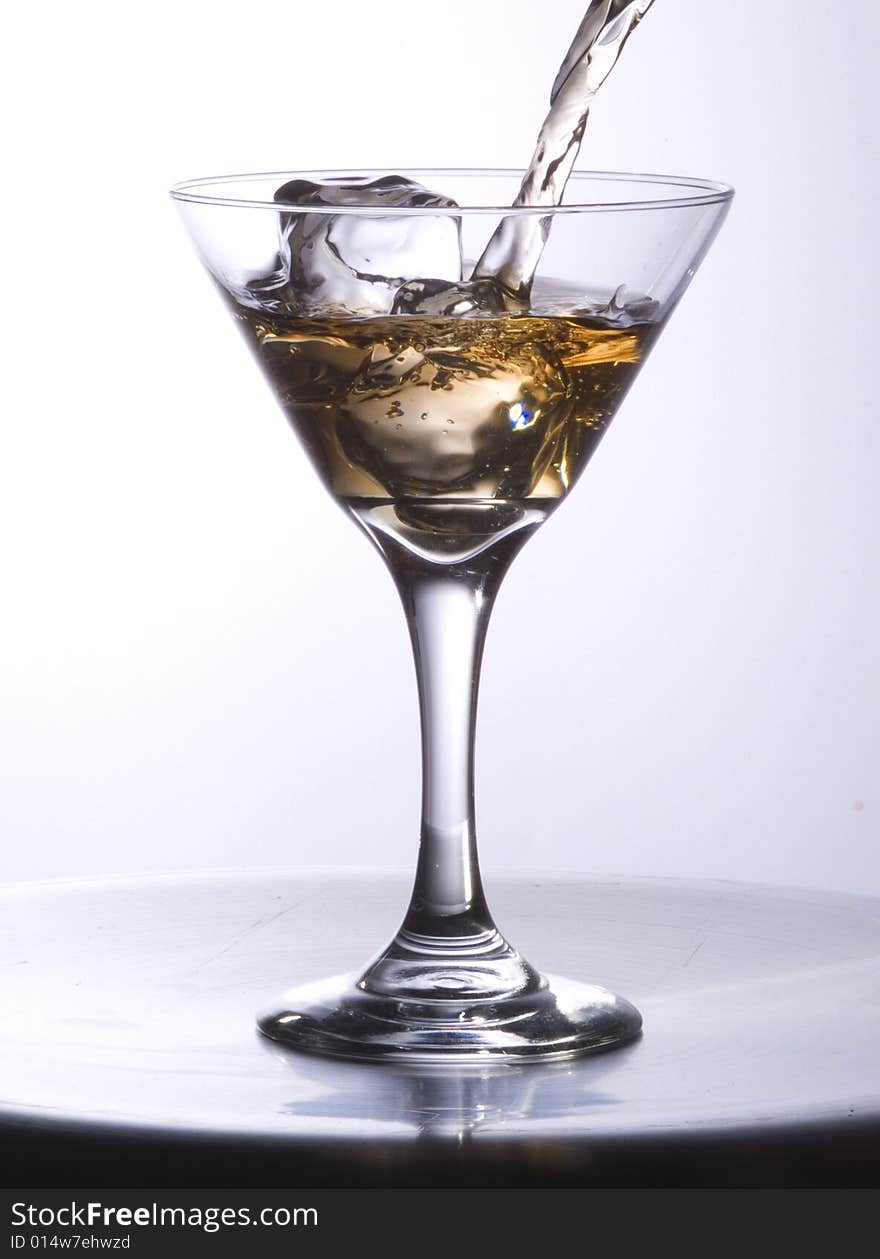 Stream of drink in a martini glass