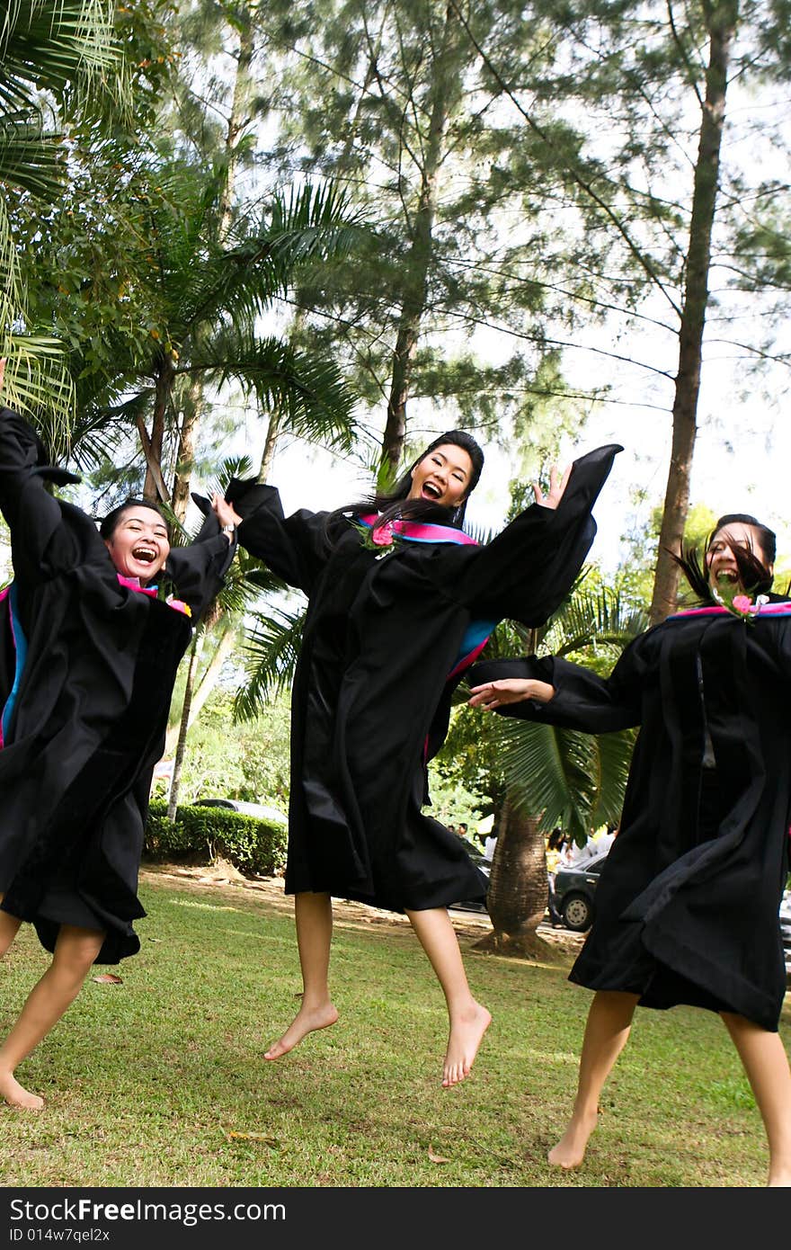 Gorgeous Asian university graduates celebrating their success.