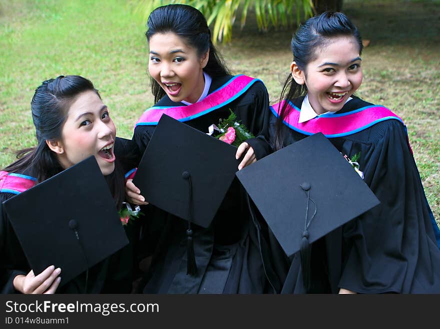 Gorgeous Asian university graduates celebrating their success.