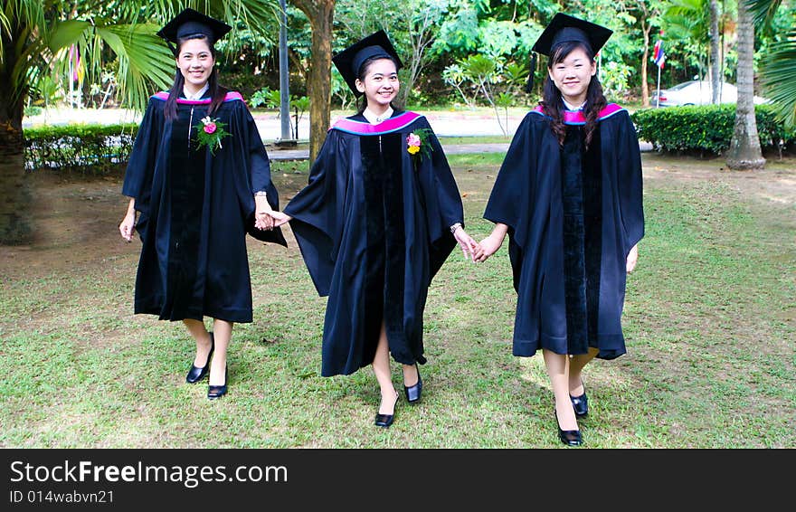 Gorgeous Asian university graduates celebrating their success.