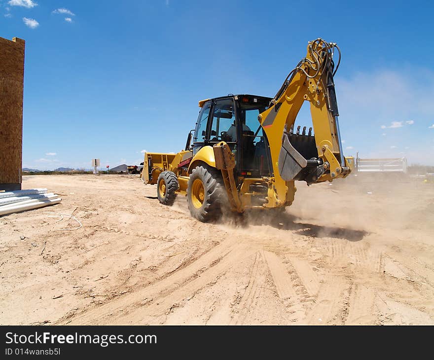 Backhoe Driving at Construction Site