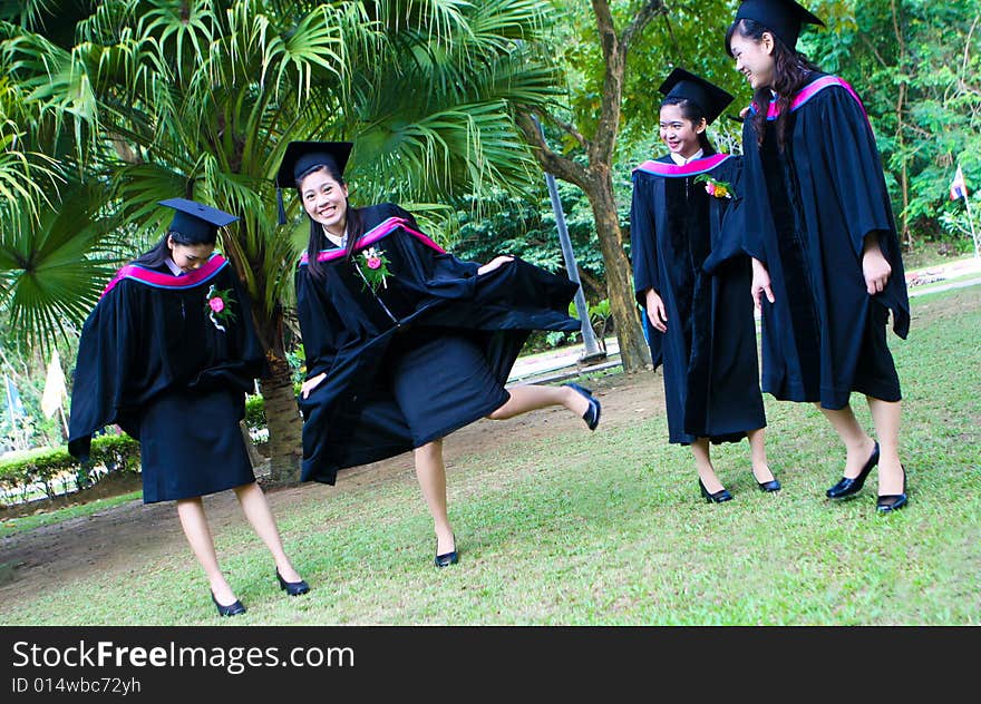 Gorgeous Asian university graduates celebrating their success.