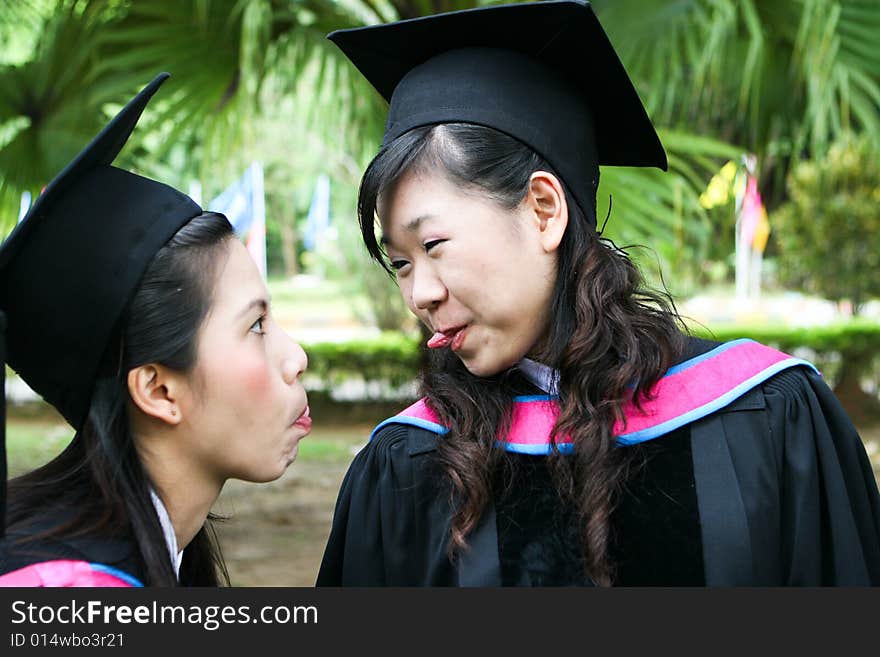 Gorgeous Asian university graduates celebrating their success.