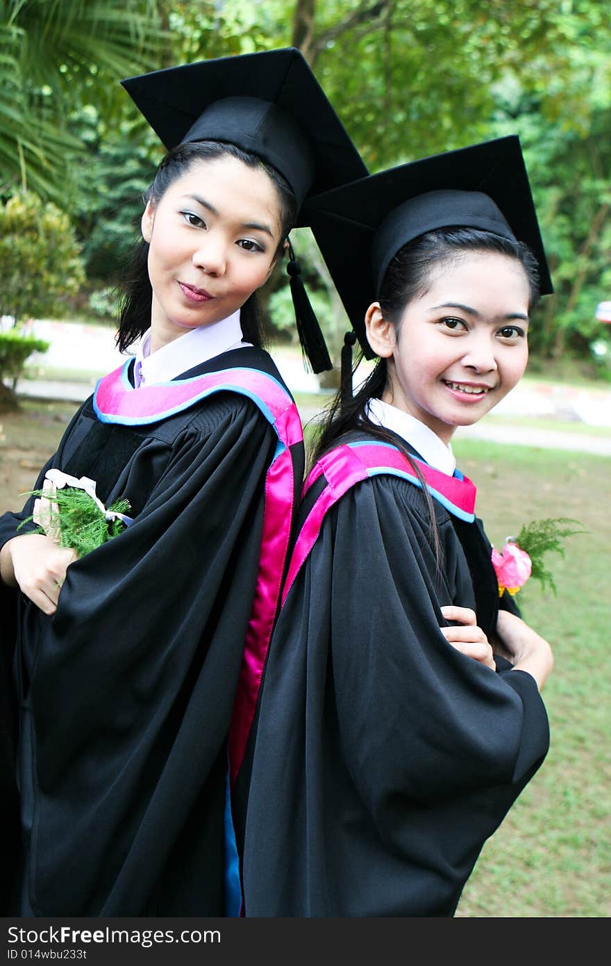 Gorgeous Asian university graduates celebrating their success.