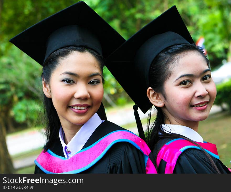 Gorgeous Asian university graduate celebrating her success.