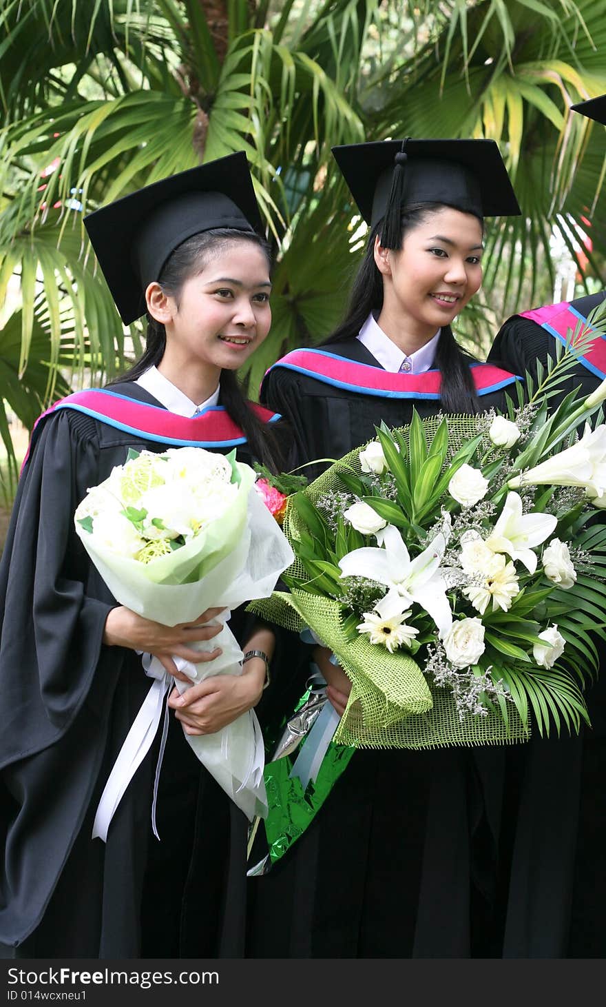 Gorgeous Asian university graduates celebrating their success.